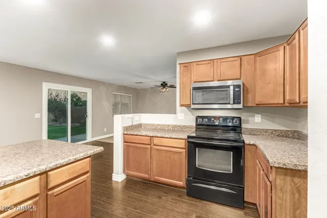 a kitchen with a stove a sink and a microwave