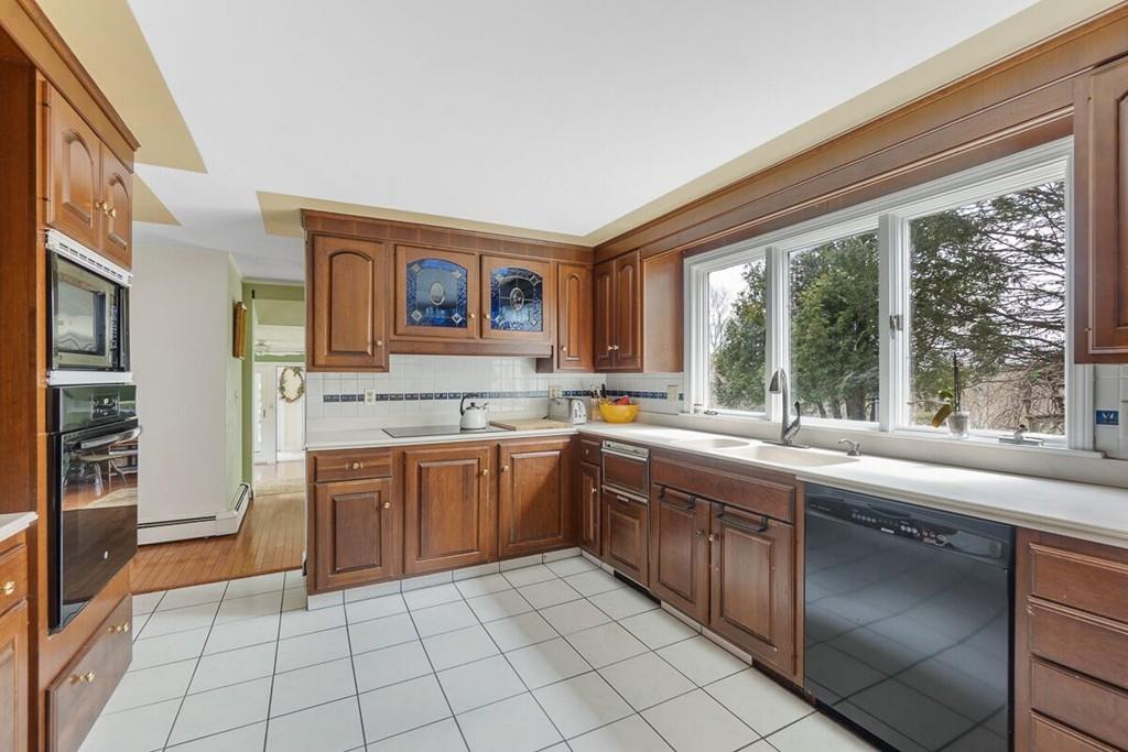 204 Sterling Road Lancaster, MA 01523 - Photo 18 of 41 a large kitchen with a stove sink and cabinets
