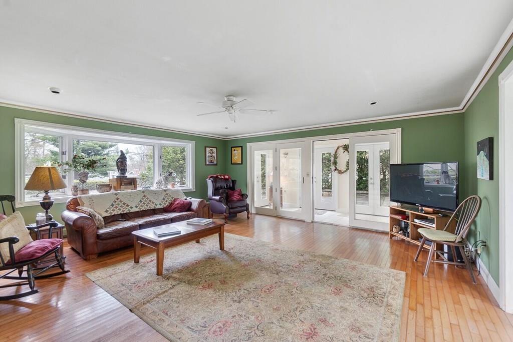 204 Sterling Road Lancaster, MA 01523 - Photo 23 of 41 a living room with furniture a piano and a flat screen tv