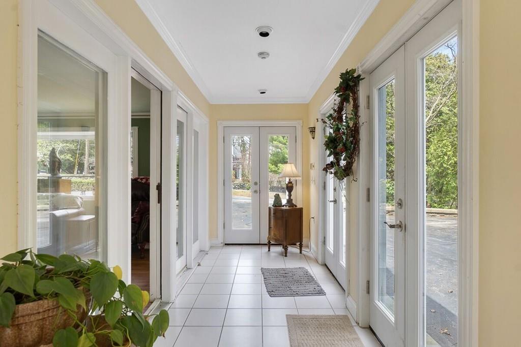 204 Sterling Road Lancaster, MA 01523 - Photo 27 of 41 a view of a hallway with a potted plant in front of a window