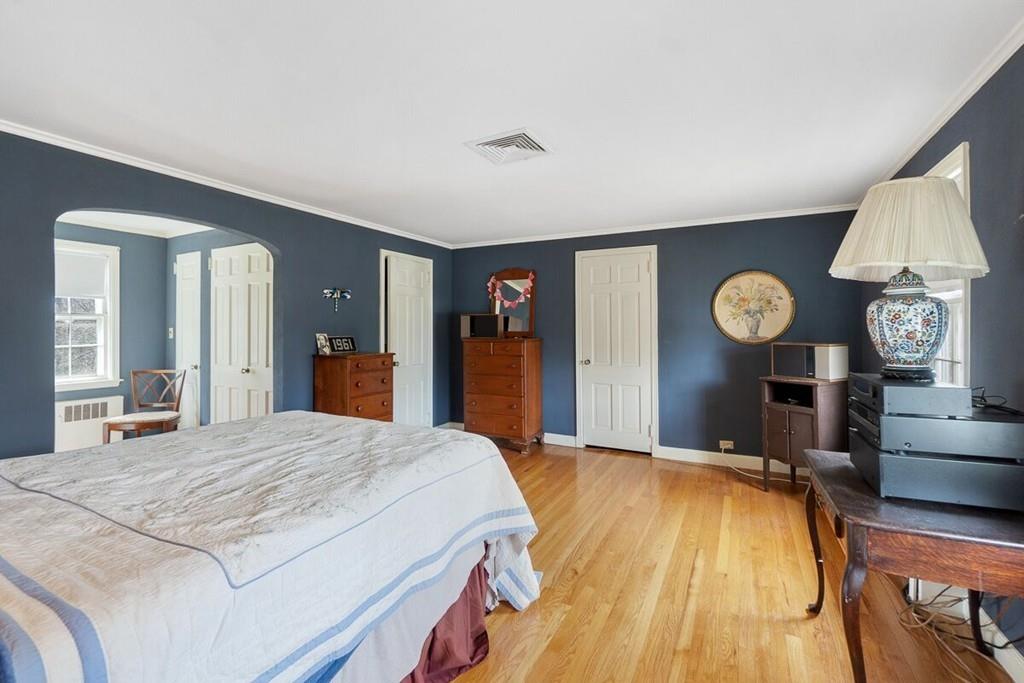 204 Sterling Road Lancaster, MA 01523 - Photo 38 of 41 a bedroom with a bed and a chandelier