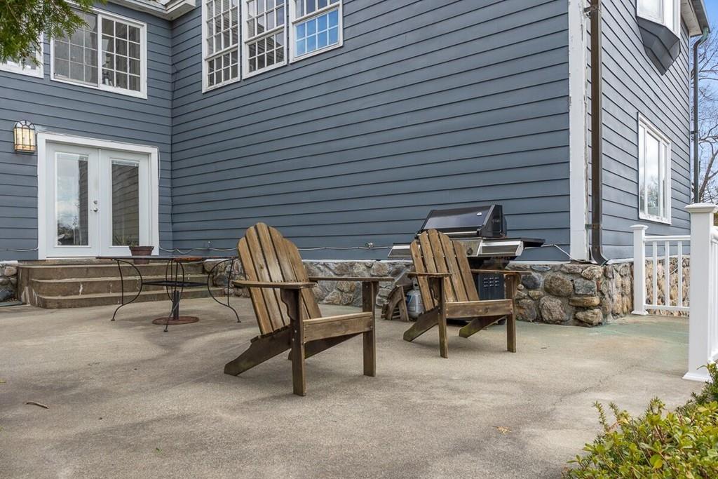 204 Sterling Road Lancaster, MA 01523 - Photo 6 of 41 a view of backyard with a table and chairs and a barbeque