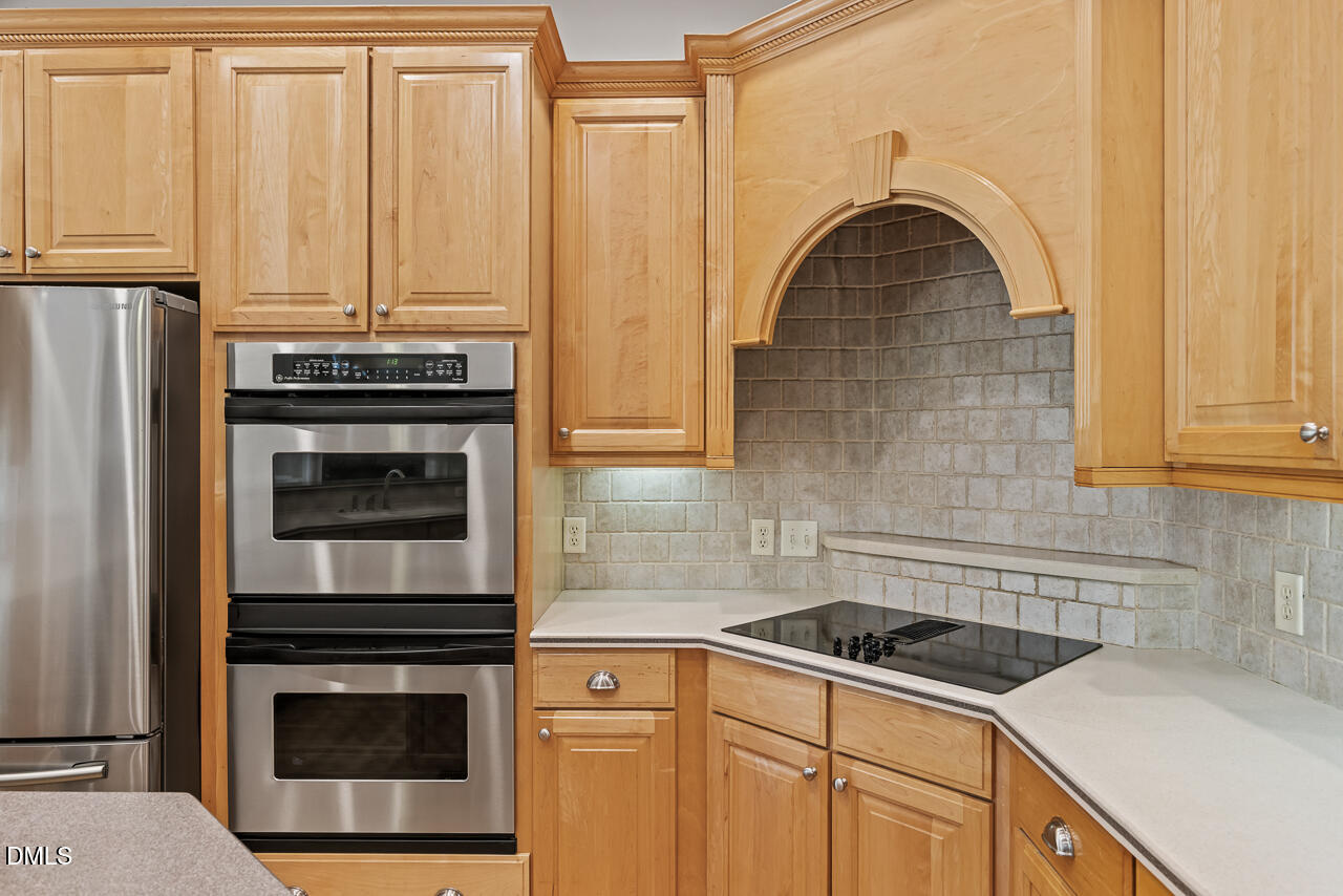 4004 Frontenac Court Apex, NC 27539 - Photo 21 of 61 a kitchen with granite countertop a sink stove and cabinets