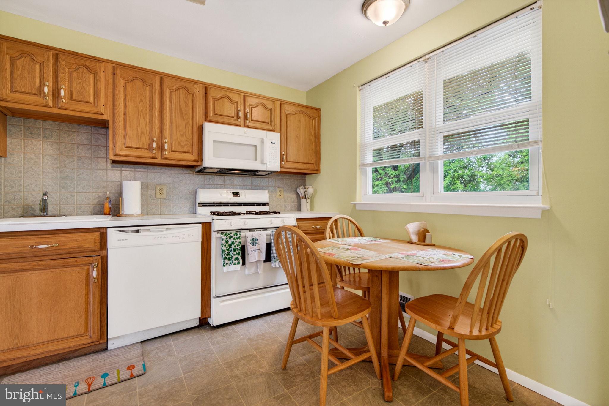 46 Trinity Avenue Marlton, NJ 08053 - Photo 11 of 37 a kitchen with stainless steel appliances kitchen island granite countertop a sink table and chairs