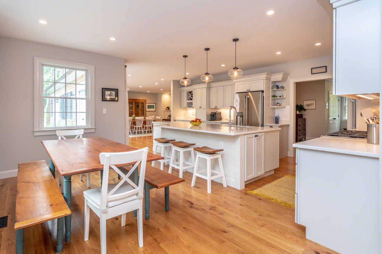 14 North Bog Road Edgartown, MA 02539 - Photo 12 of 46 a dining room with stainless steel appliances kitchen island granite countertop a table chairs and a refrigerator
