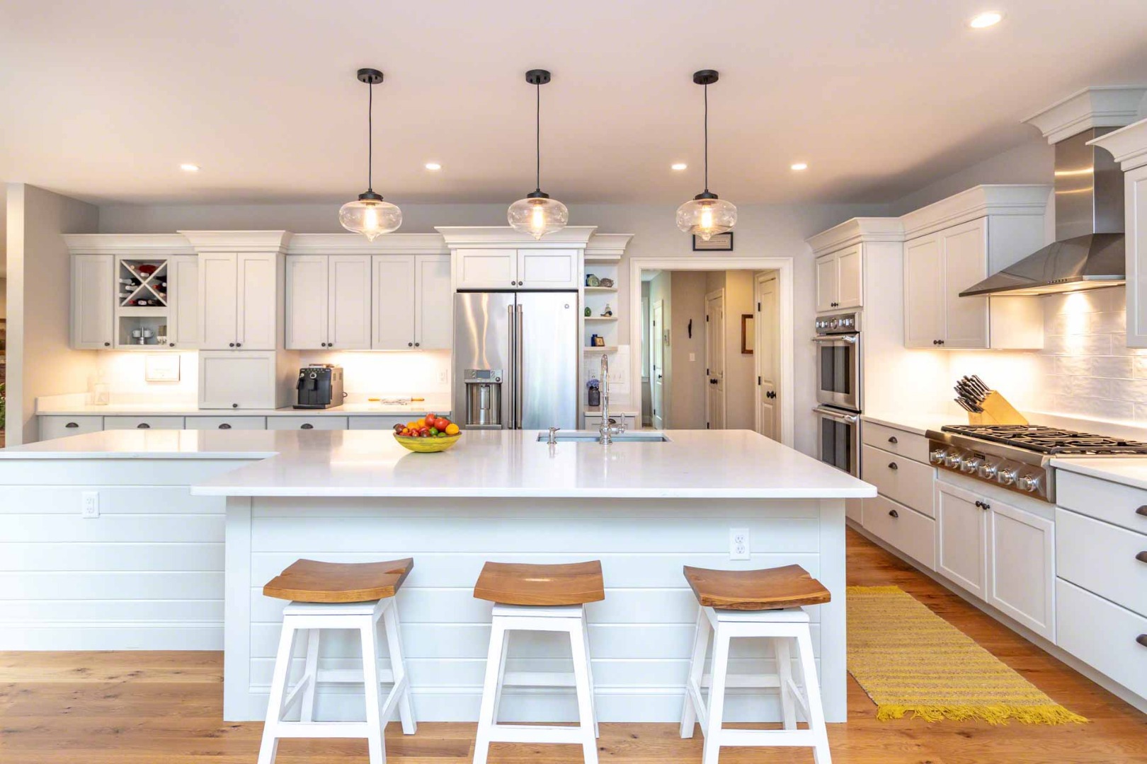 14 North Bog Road Edgartown, MA 02539 - Photo 14 of 46 a kitchen with stainless steel appliances kitchen island granite countertop a table chairs stove and white cabinets