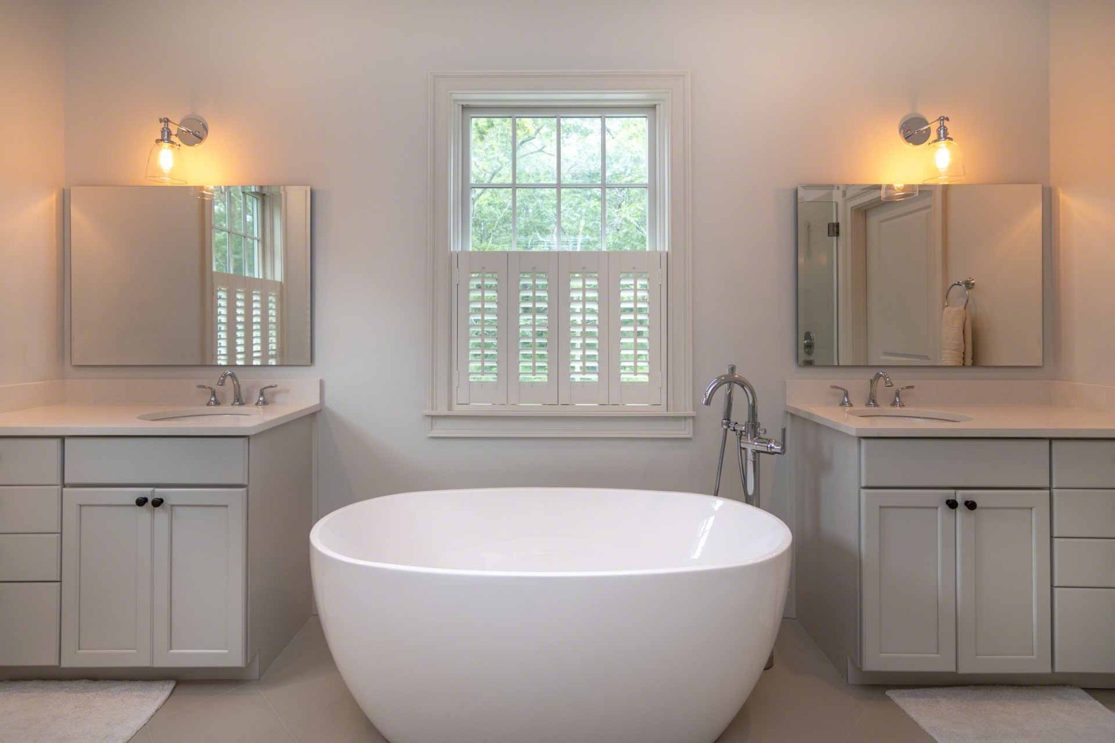 14 North Bog Road Edgartown, MA 02539 - Photo 25 of 46 a bathroom with a bathtub a sink a window and a mirror