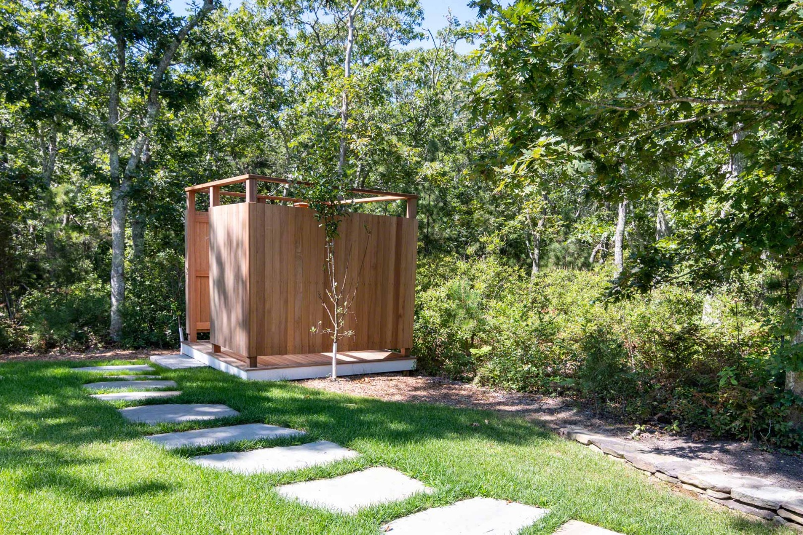 14 North Bog Road Edgartown, MA 02539 - Photo 46 of 46 a view of a backyard with potted plants and large trees