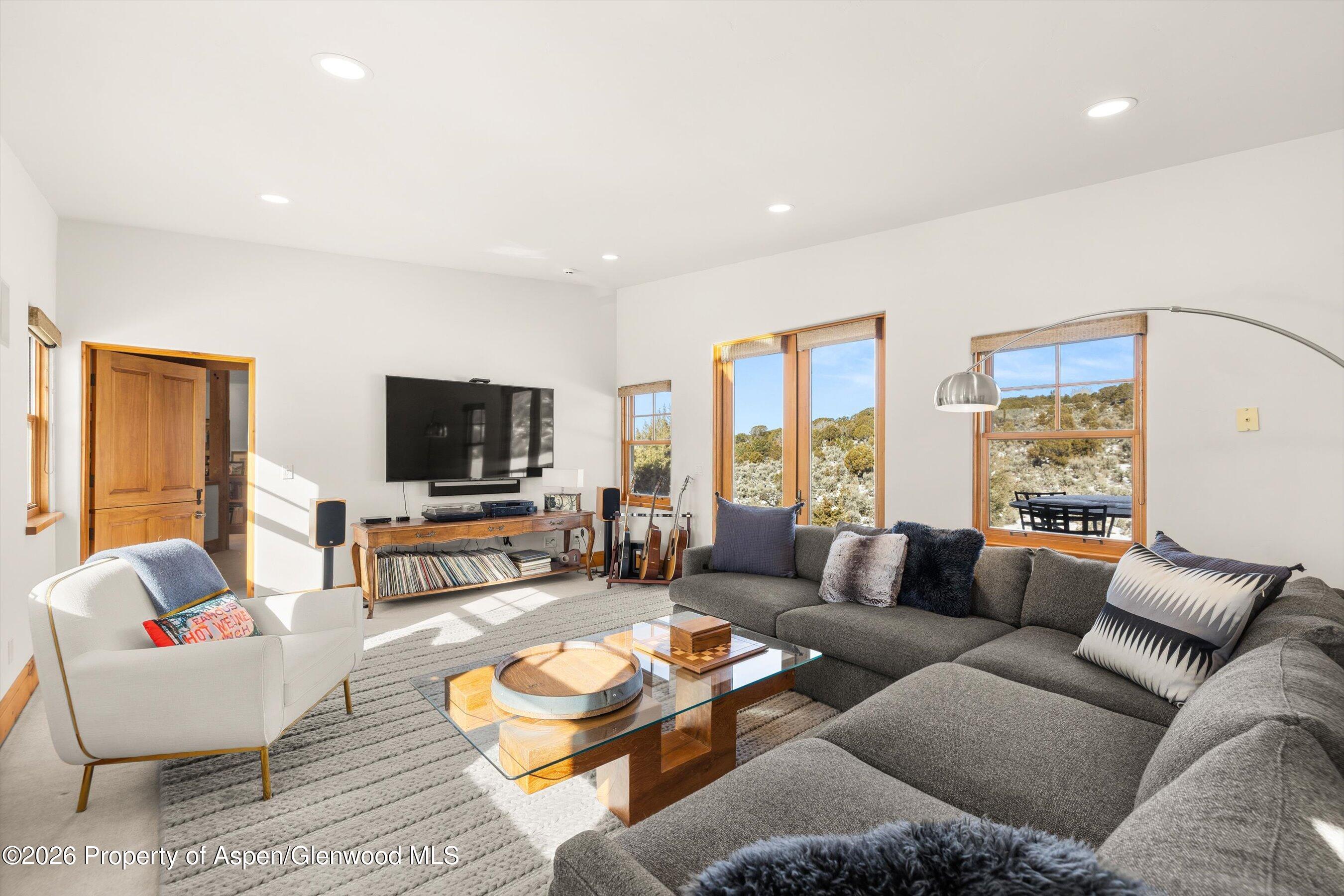 31 Wind River Road Carbondale, CO 81623 - Photo 15 of 46 a living room with furniture and a flat screen tv