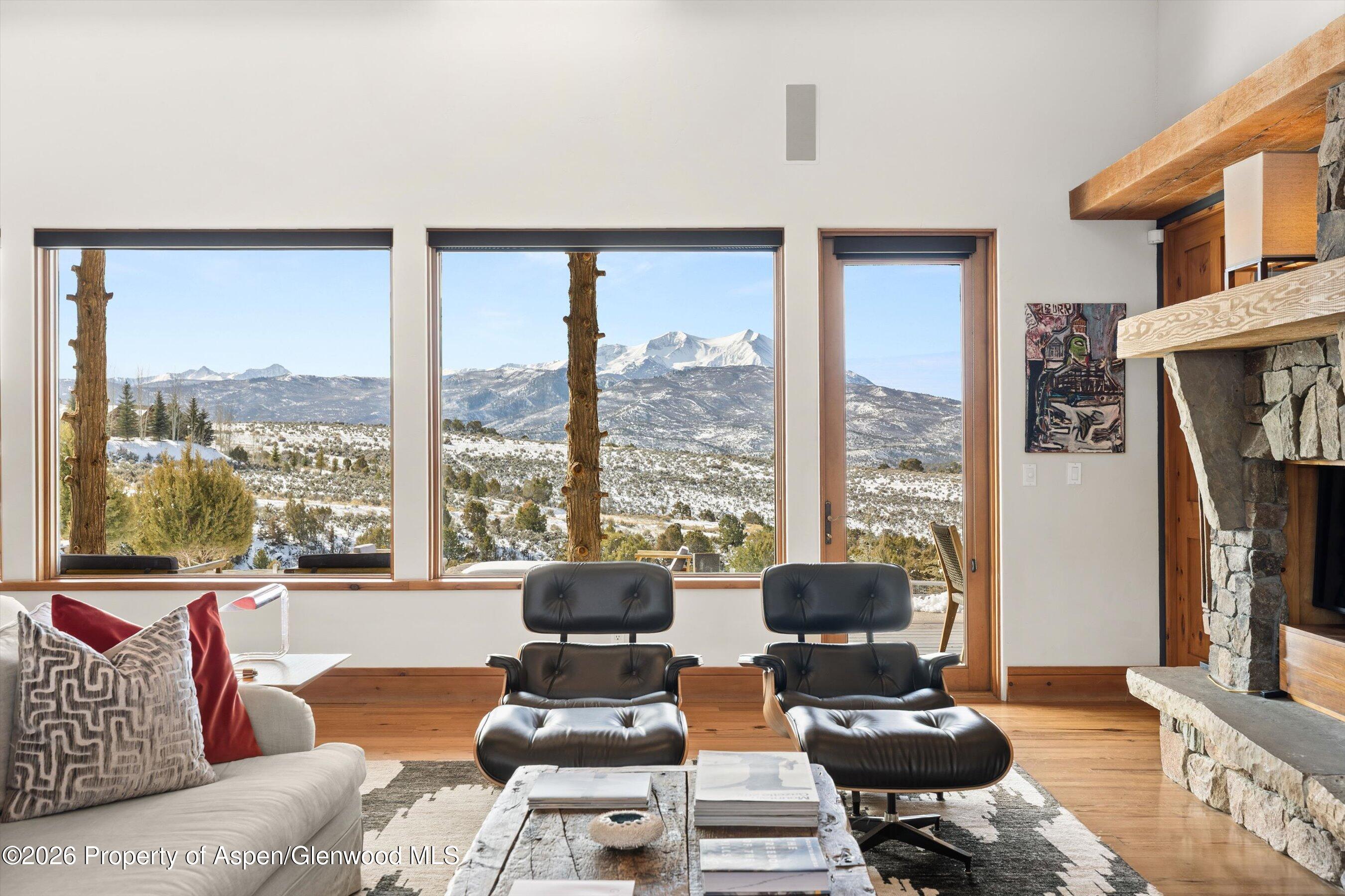 31 Wind River Road Carbondale, CO 81623 - Photo 21 of 46 a living room with furniture and a floor to ceiling window