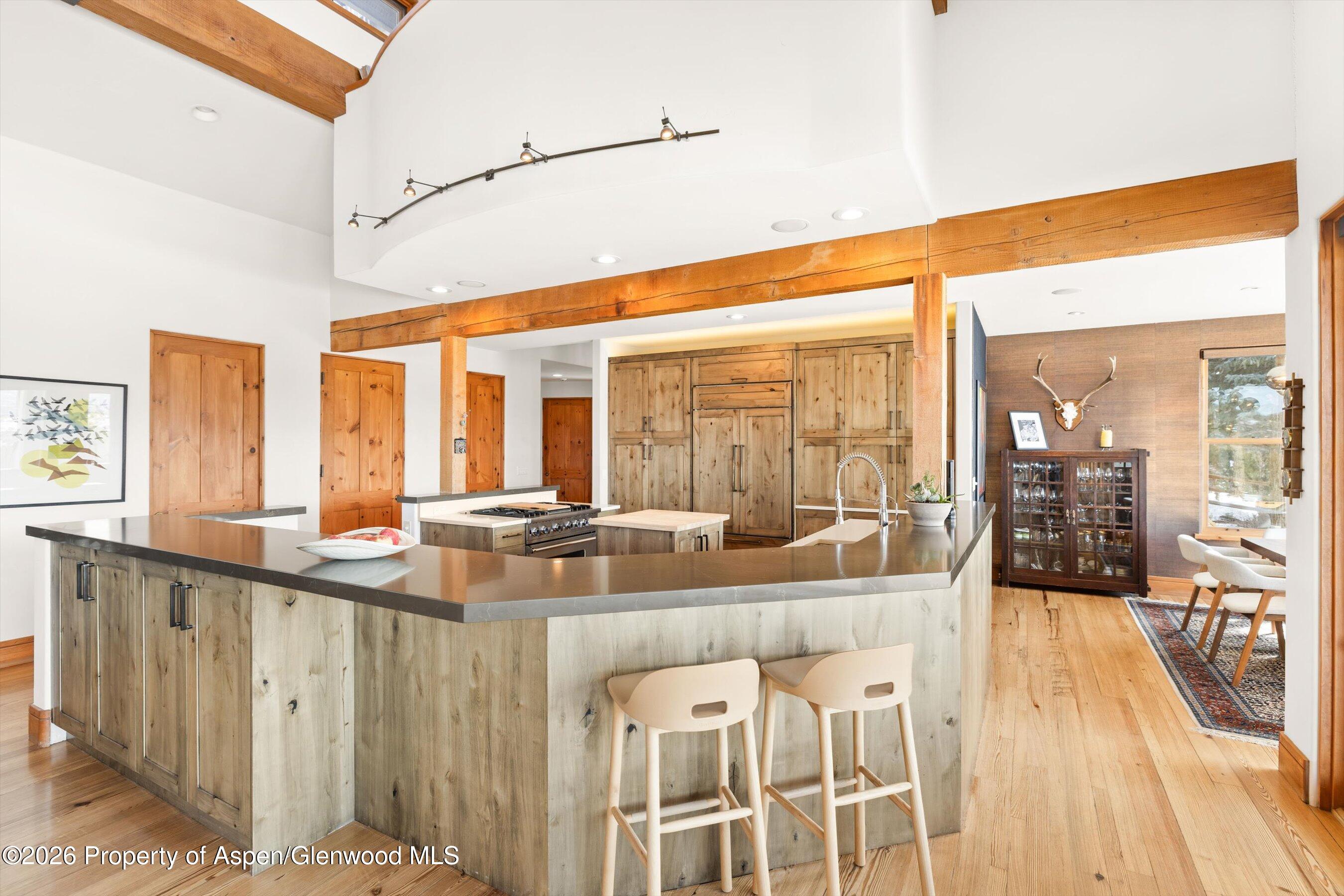 31 Wind River Road Carbondale, CO 81623 - Photo 22 of 46 a large white kitchen with kitchen island granite countertop a large window