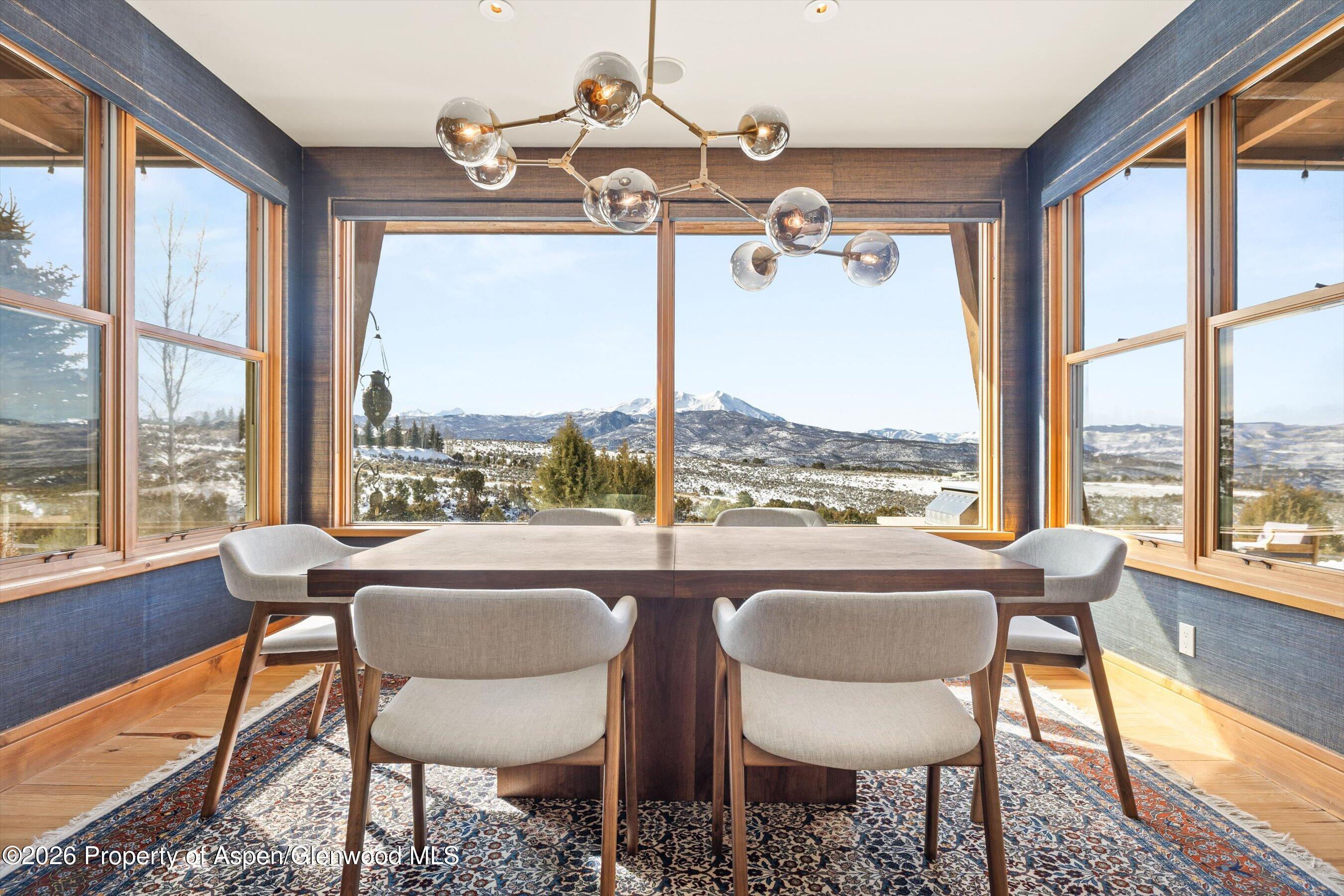 31 Wind River Road Carbondale, CO 81623 - Photo 27 of 46 a dining room with furniture a chandelier and wooden floor