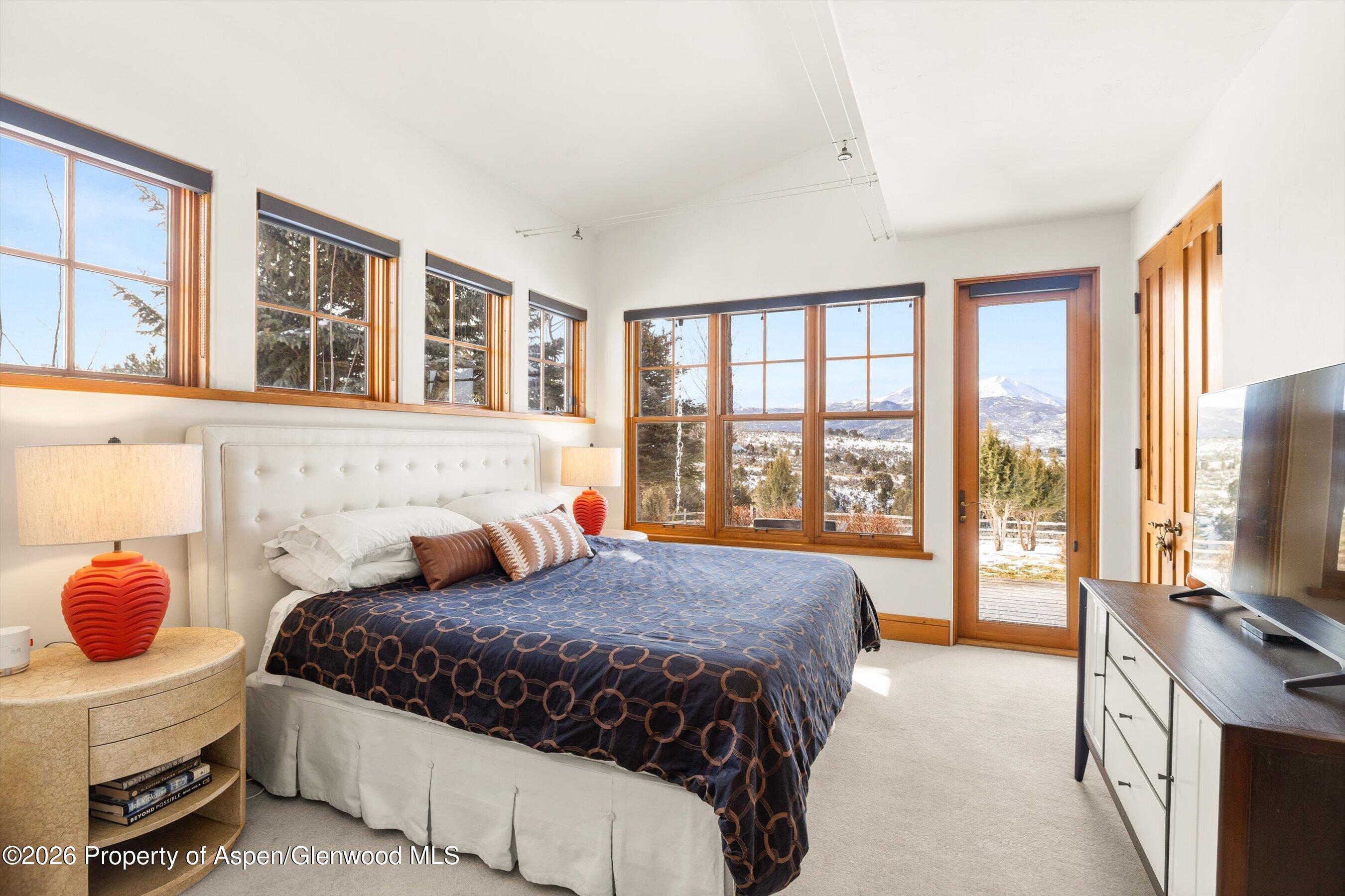 31 Wind River Road Carbondale, CO 81623 - Photo 30 of 46 a bedroom with a large bed and a large window