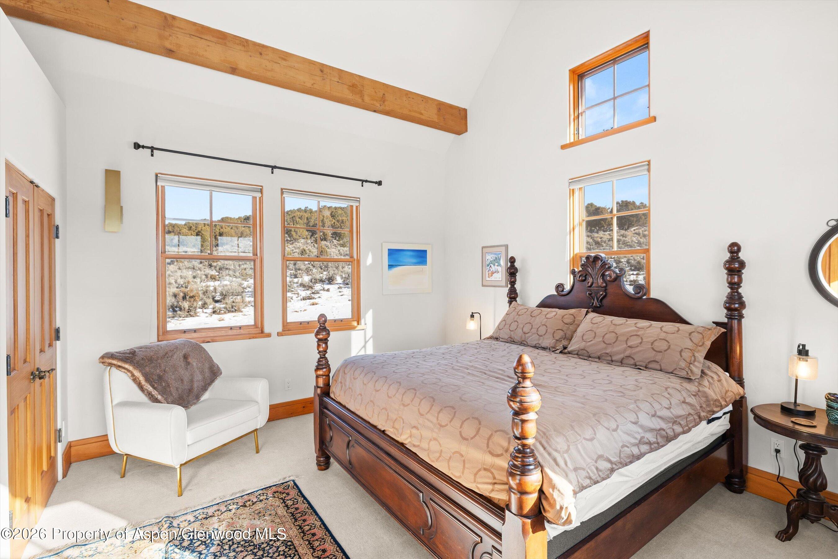 31 Wind River Road Carbondale, CO 81623 - Photo 33 of 46 a bedroom with a bed and a large window