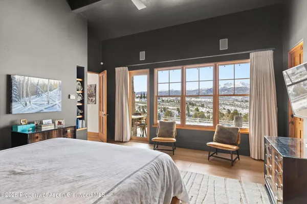 a living room with furniture and a floor to ceiling window