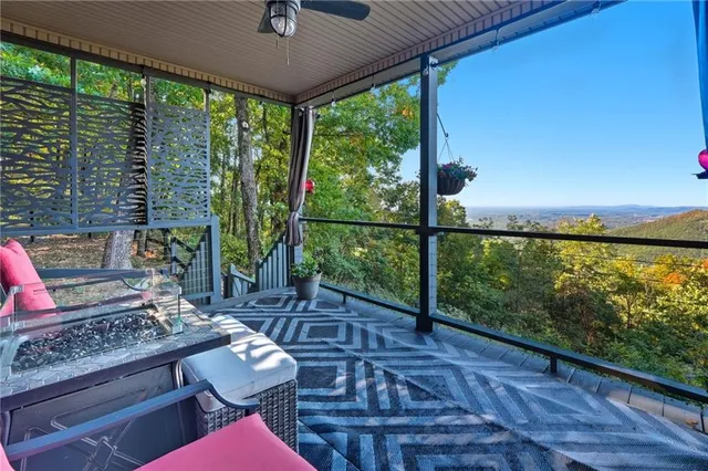 a dining room with wooden floor glass table and a floor to ceiling window