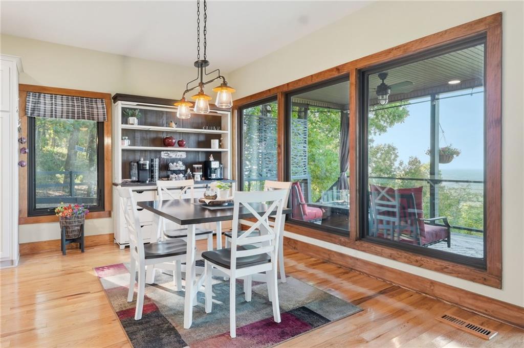 49 Rimrock Road Jasper, GA 30143 - Photo 18 of 61 a dining room with wooden floor glass table and a floor to ceiling window