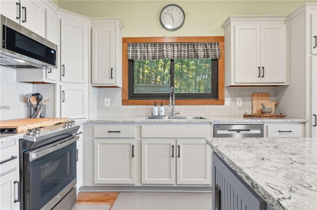 49 Rimrock Road Jasper, GA 30143 - Photo 20 of 61 a kitchen with stainless steel appliances granite countertop a stove and a sink