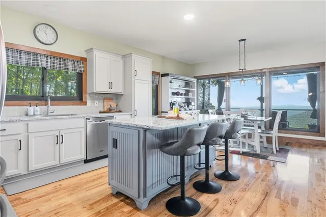 a spacious bedroom with a bed and a flat screen tv