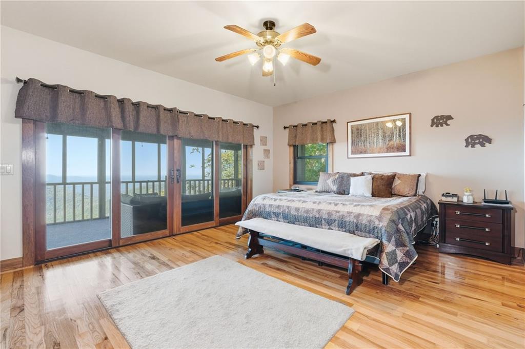 49 Rimrock Road Jasper, GA 30143 - Photo 22 of 61 a bedroom with a large bed and a chandelier fan