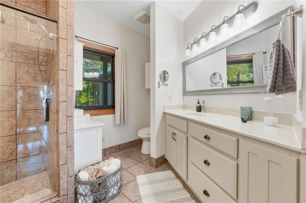 49 Rimrock Road Jasper, GA 30143 - Photo 28 of 61 a spacious bathroom with double vanity sink a mirror and a shower