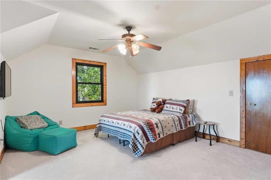 49 Rimrock Road Jasper, GA 30143 - Photo 34 of 61 a bedroom with a bed and a chandelier