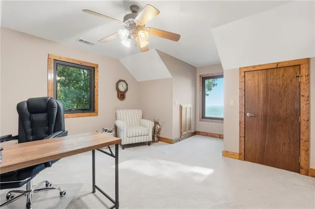 a spacious bedroom with a bed and a chandelier