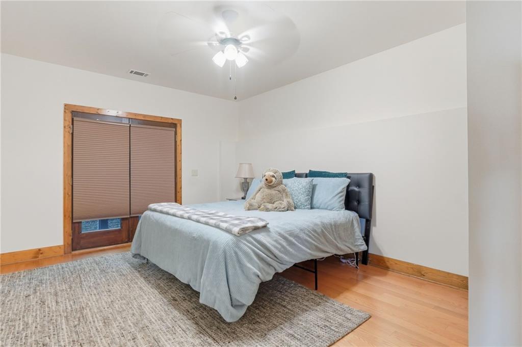 49 Rimrock Road Jasper, GA 30143 - Photo 41 of 61 a spacious bedroom with a bed and a chandelier