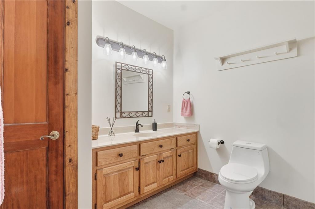 49 Rimrock Road Jasper, GA 30143 - Photo 43 of 61 a bathroom with a toilet sink and mirror