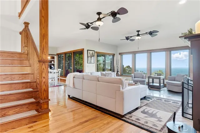 a living room with furniture fireplace and a large window