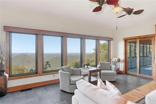 a living room with furniture and a floor to ceiling window
