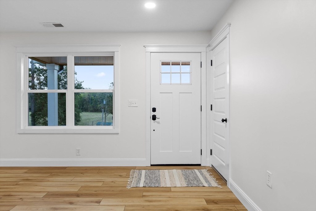 446 Brown Bridge Road Chatsworth, GA 30705 - Photo 44 of 77 a view of an empty room with wooden floor and a window