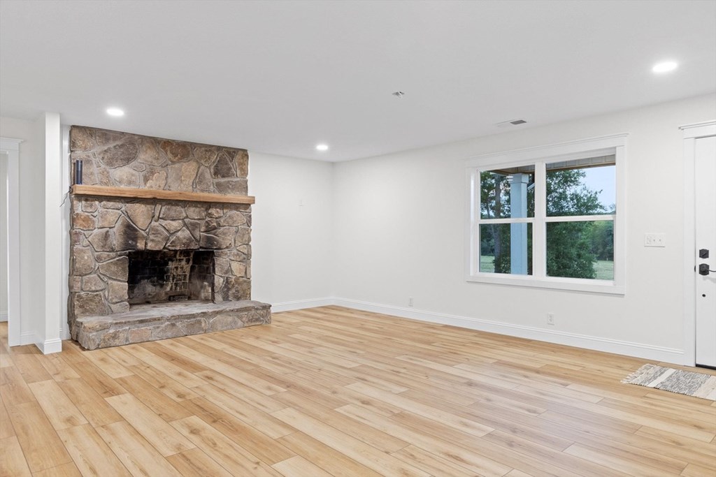 446 Brown Bridge Road Chatsworth, GA 30705 - Photo 47 of 77 a view of an empty room with a fireplace and a window