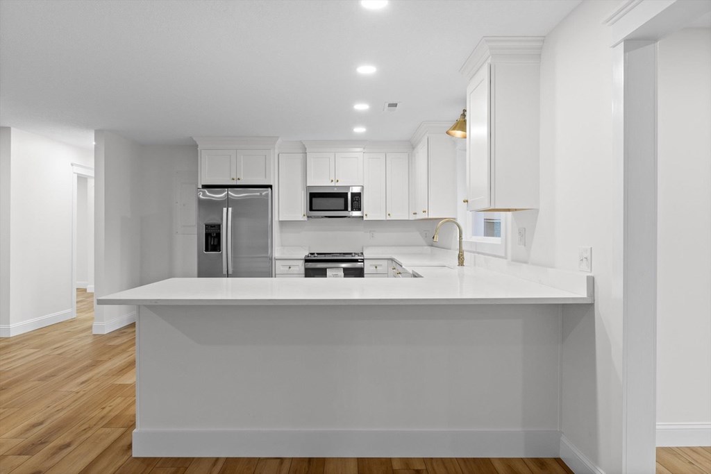 446 Brown Bridge Road Chatsworth, GA 30705 - Photo 51 of 77 a kitchen with stainless steel appliances a sink a stove a refrigerator cabinets and a counter top space