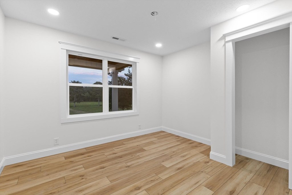 446 Brown Bridge Road Chatsworth, GA 30705 - Photo 63 of 77 a view of an empty room with wooden floor and a window