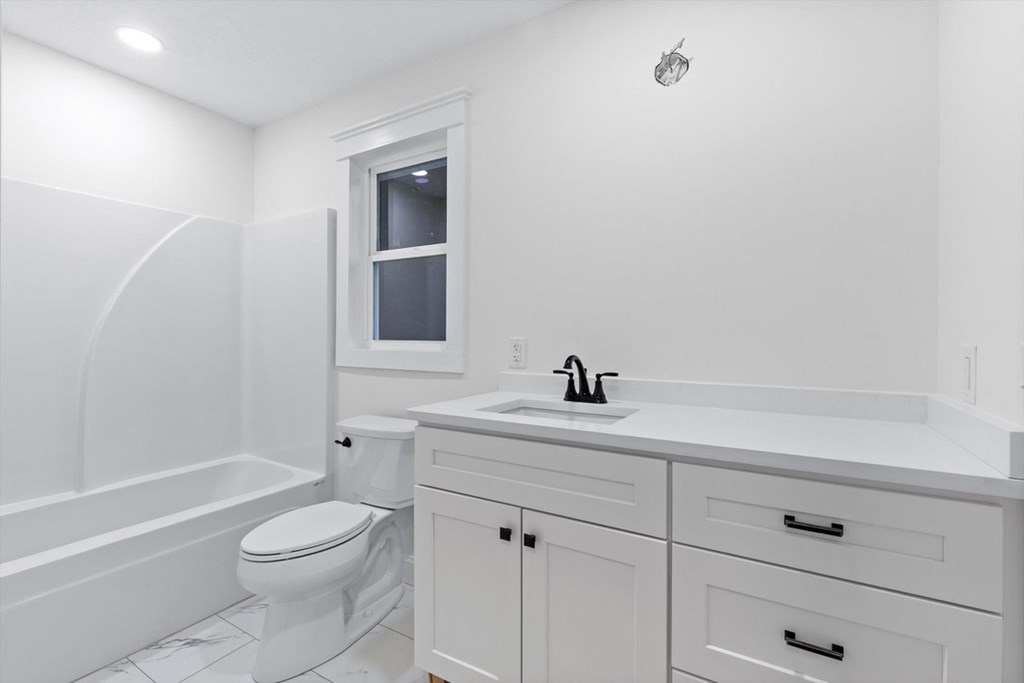 446 Brown Bridge Road Chatsworth, GA 30705 - Photo 67 of 77 a bathroom with a toilet a sink a mirror and vanity