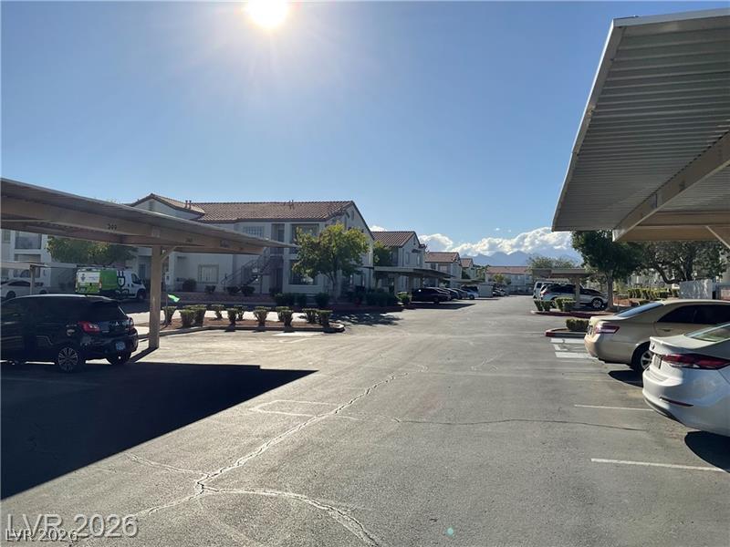 3318 North Decatur Boulevard, Unit 2152 Las Vegas, NV 89130 - Photo 35 of 58 Covered parking structures and lush landscaping frame this vibrant community setting.