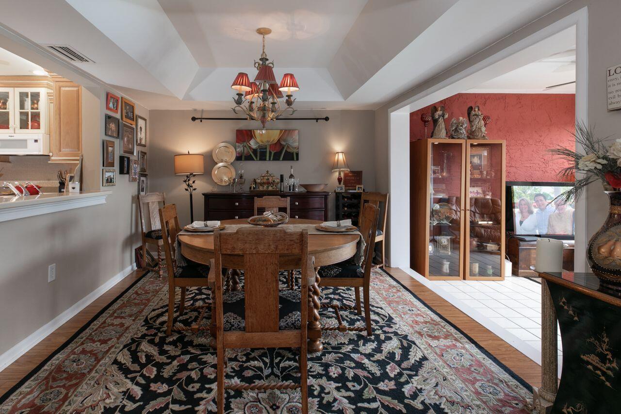 5606 Southeast Foxcross Place Stuart, FL 34997 - Photo 14 of 65 a view of a dining room with furniture window and wooden floor