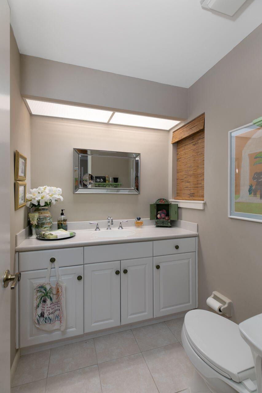 5606 Southeast Foxcross Place Stuart, FL 34997 - Photo 17 of 65 a bathroom with a toilet sink and mirror