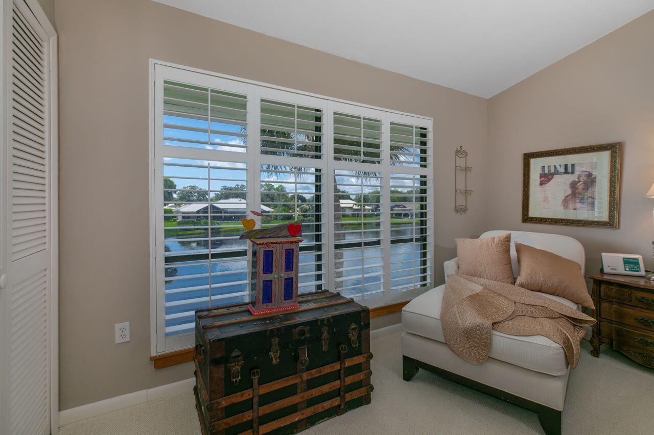 5606 Southeast Foxcross Place Stuart, FL 34997 - Photo 21 of 65 a living room with furniture a large window and potted plants