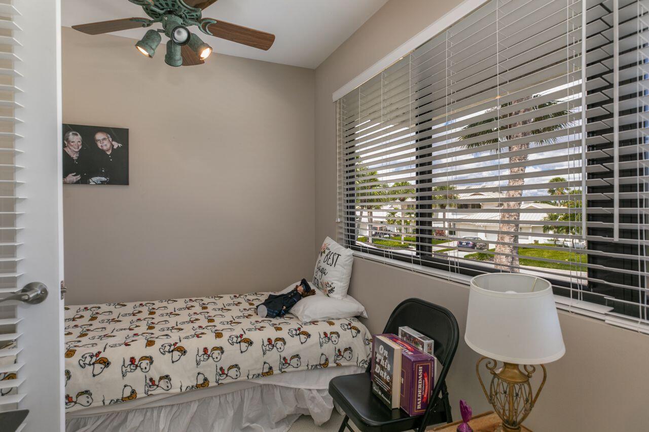 5606 Southeast Foxcross Place Stuart, FL 34997 - Photo 25 of 65 a bedroom with a bed and a window