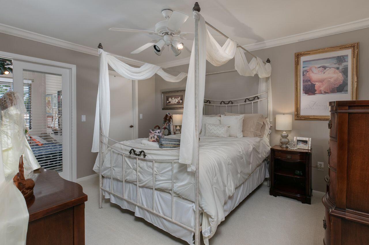 5606 Southeast Foxcross Place Stuart, FL 34997 - Photo 26 of 65 a bedroom with a bed and wooden floor