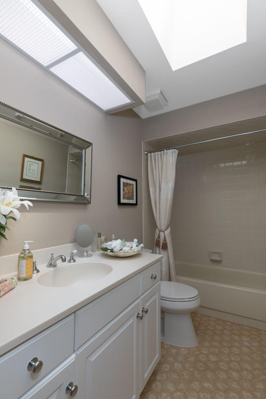 5606 Southeast Foxcross Place Stuart, FL 34997 - Photo 27 of 65 a bathroom with a sink a toilet and mirror