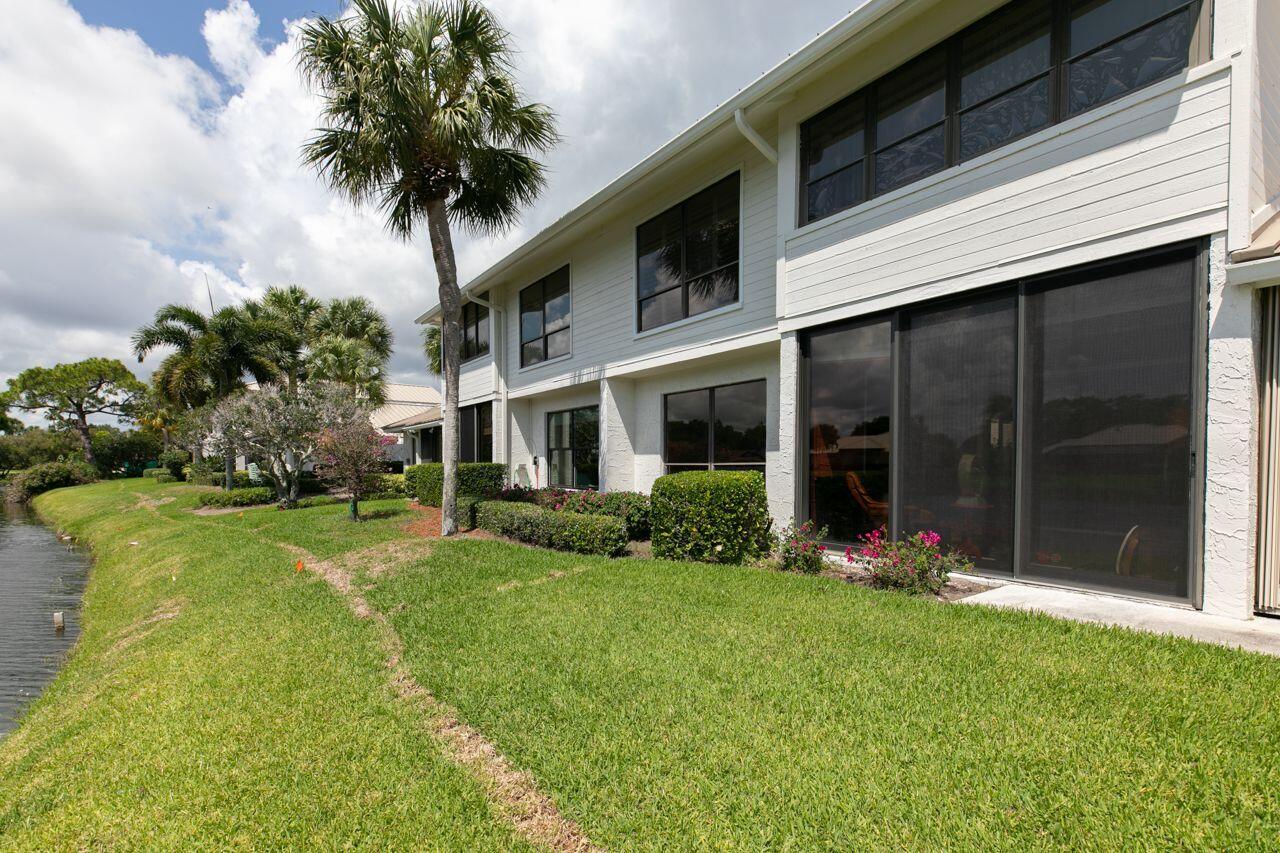 5606 Southeast Foxcross Place Stuart, FL 34997 - Photo 33 of 65 a front view of a house with a yard and garage