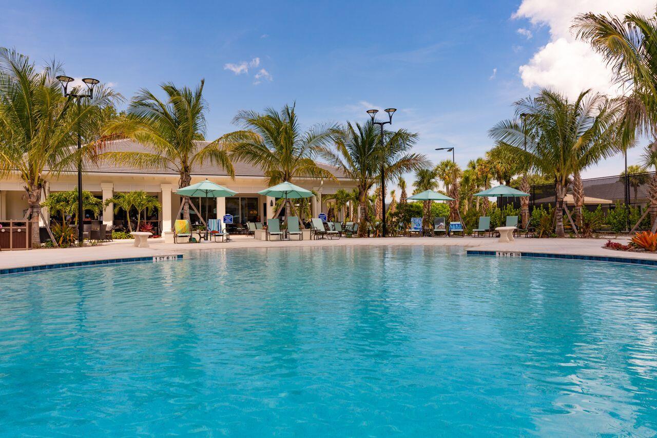 5606 Southeast Foxcross Place Stuart, FL 34997 - Photo 47 of 65 a view of pool with outdoor seating and house in the background