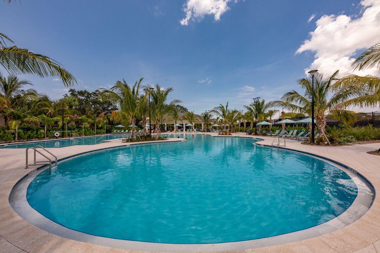 5606 Southeast Foxcross Place Stuart, FL 34997 - Photo 48 of 65 a view of a swimming pool with a yard