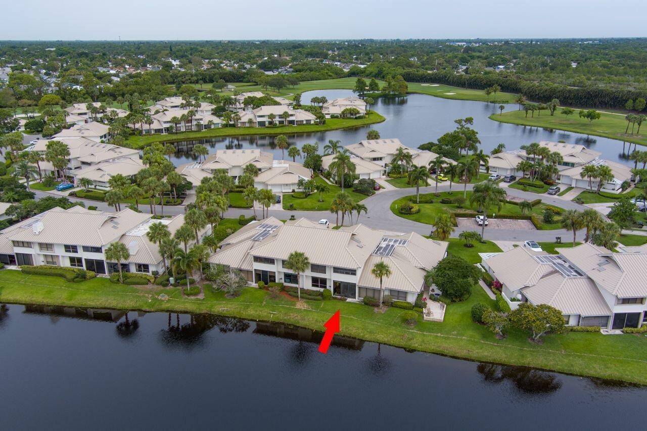 5606 Southeast Foxcross Place Stuart, FL 34997 - Photo 5 of 65 an aerial view of residential houses with outdoor space and lake view