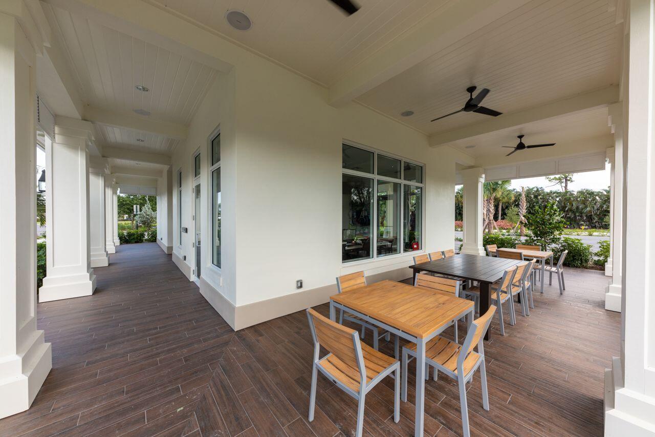 5606 Southeast Foxcross Place Stuart, FL 34997 - Photo 59 of 65 a view of a patio with a dining table and chairs