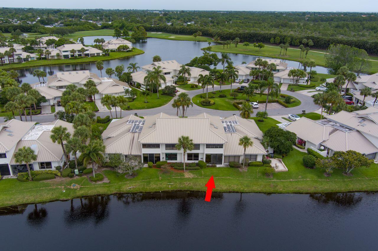 5606 Southeast Foxcross Place Stuart, FL 34997 - Photo 6 of 65 an aerial view of a house with a lake view