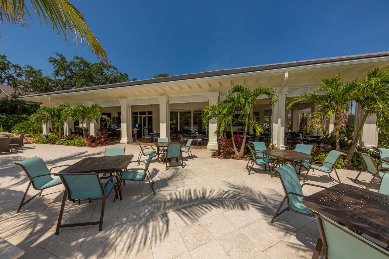 5606 Southeast Foxcross Place Stuart, FL 34997 - Photo 64 of 65 a view of a patio with table and chairs and potted plants